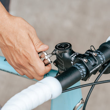 Person using Granite Diverse 10 multi tool adjusting a bicycle stem with Ritchey branding.
