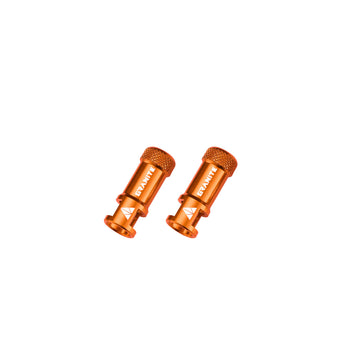 Two Granite JUICY NIPPLE CNC Valve cap orange metal components with  branding on a white background
