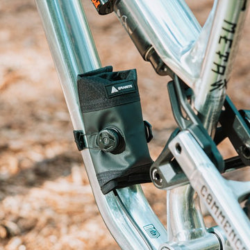 Granite Quiver tool roll on bike frame with dial closure, providing secure attachment and easy access for tools and essentials during rides.