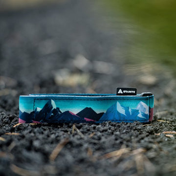 Granite Rockband with mountain landscape design lies on gravel, blending rugged style with practical bike storage solution.