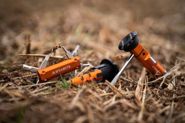 Granite multitool and Granite Stash chain tool placed on dry grasses