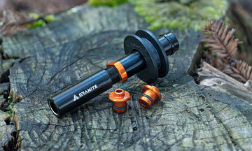 Black and orange Granite Chaindock dummy hub on a wooden stump