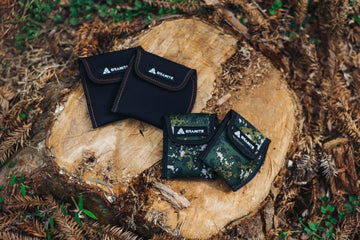 Four Granite Pita pedal covers on a wooden log surrounded by natural elements.