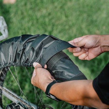 Person adjusting a Granite Crust Tire Cover outdoors.