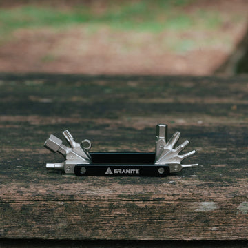 Granite Diverse 10 multi tool with its bits fanned out on a wooden board