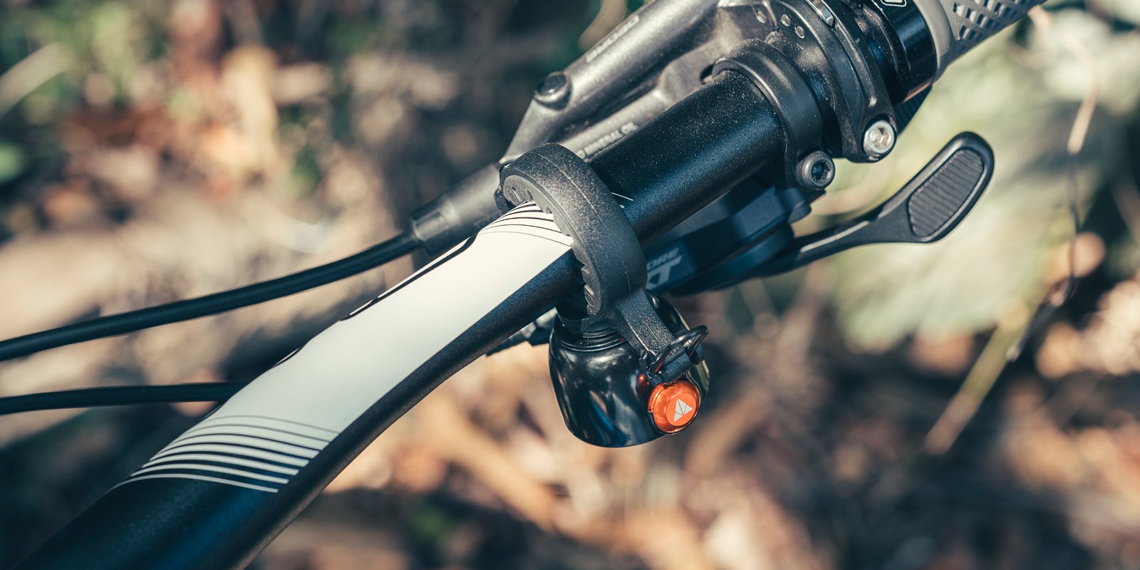 Close-up of a bike handlebar featuring a Granite Cricket bike bell.