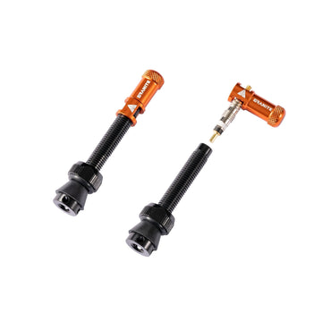 Granite MTB tubeless valve kit with orange aluminum valve cores and black stems for mountain bike tire sealant setup