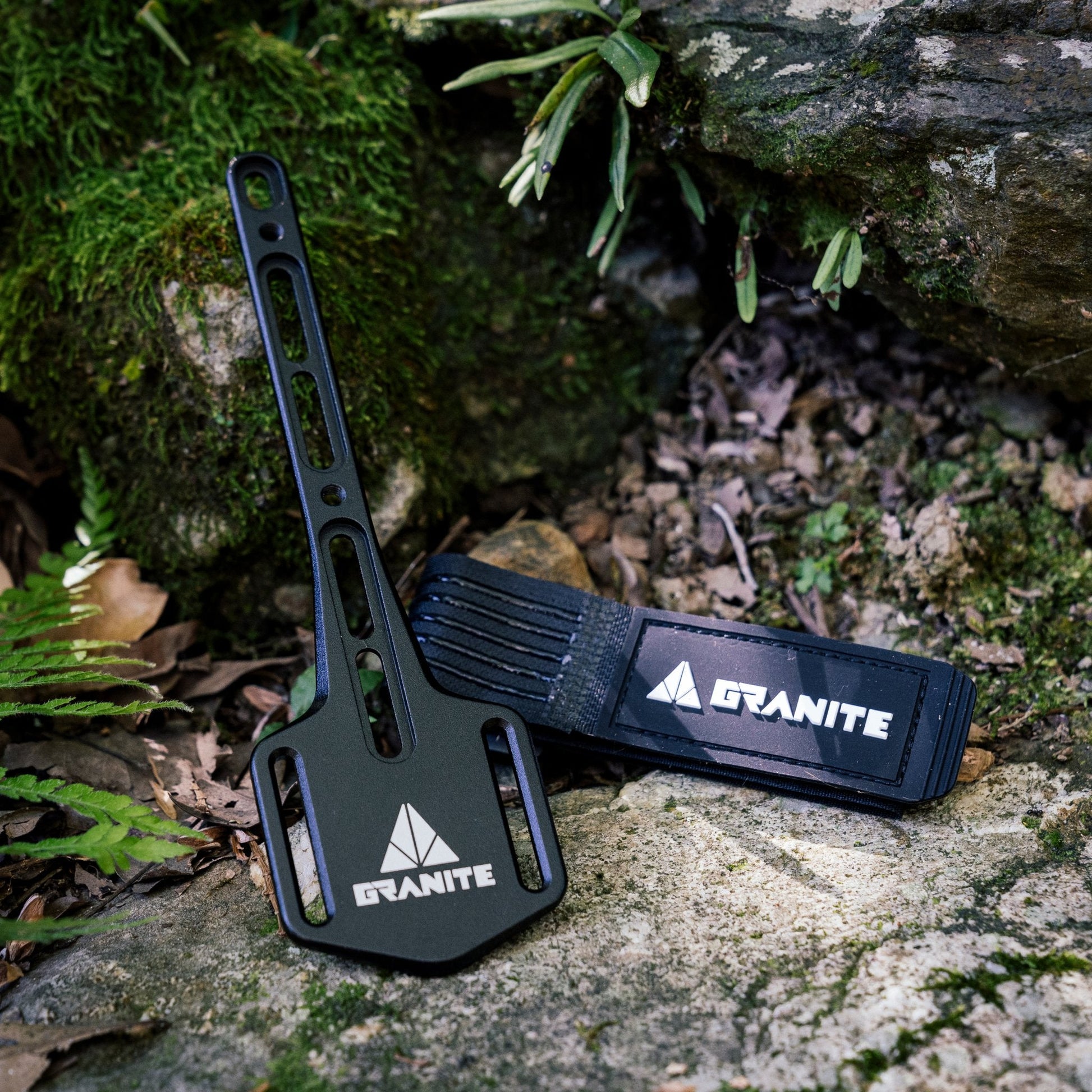 Granite Portaledge XE Strap Mount placed outdoors on mossy rocks.