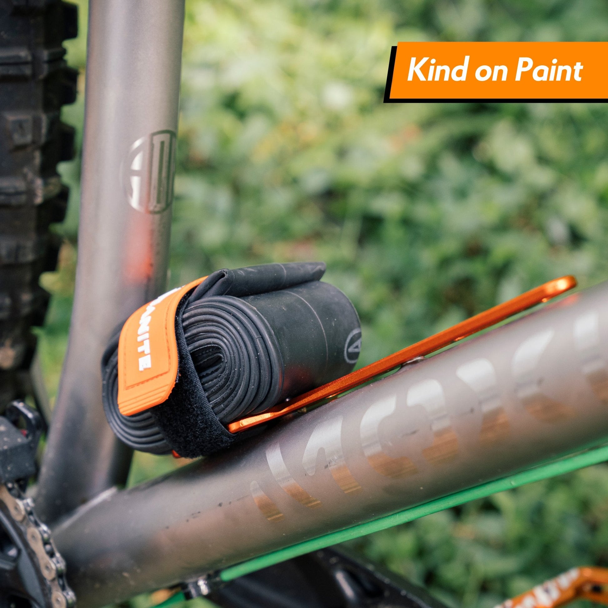 Granite Portaledge XE Strap Mount  securely holding a tube on a bike frame with 'Kind on Paint' text overlay