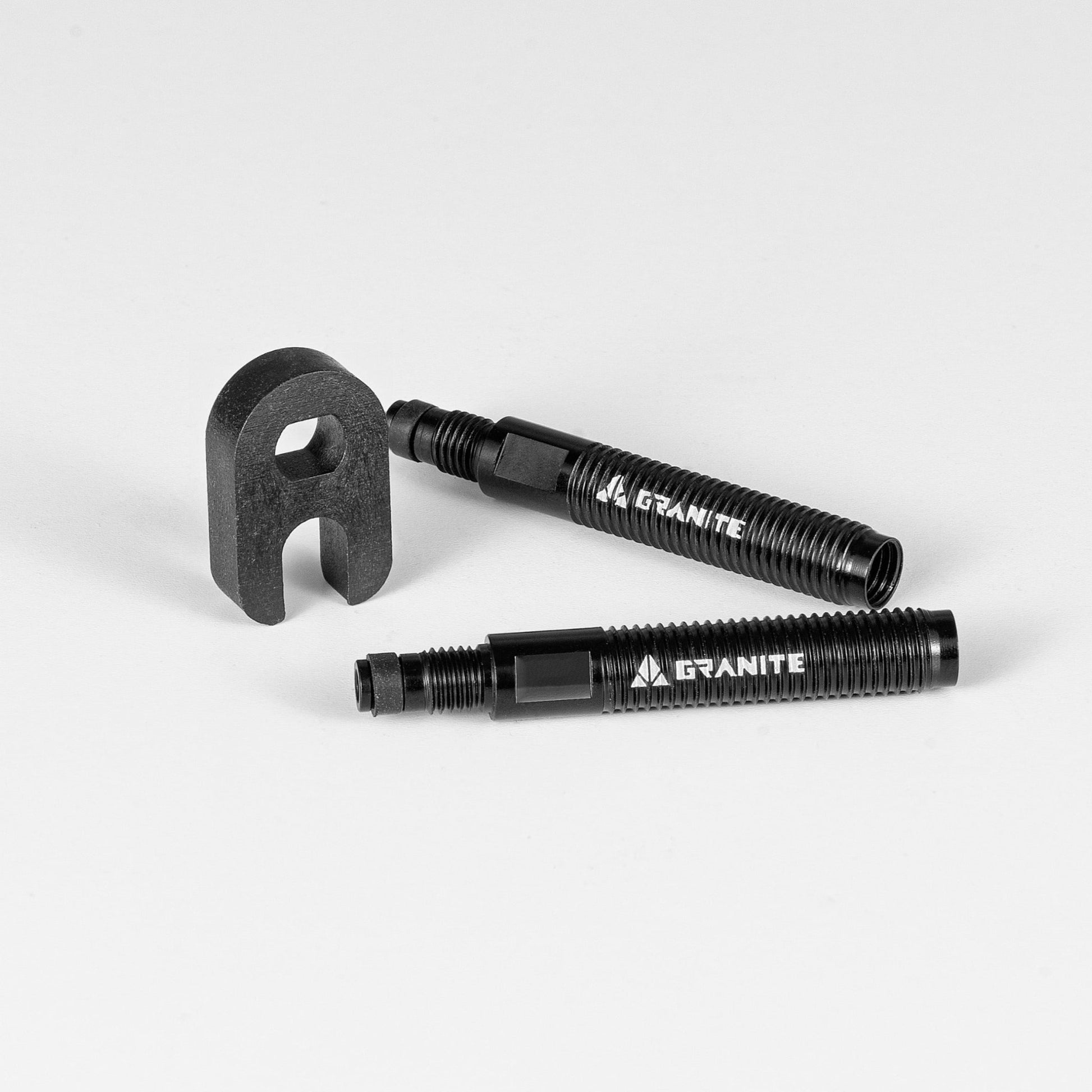 Two Granite Presta valve stem extenders with a black removal tool on a white background.