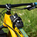 Granite Rockband frame strap securing a spare inner tube, tire levers, and CO2 cartridges to the top tube of a yellow bike.