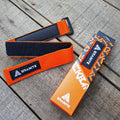 Orange Granite Rockband frame strap with Velcro and rubber grip, displayed next to its branded packaging on a wooden surface.