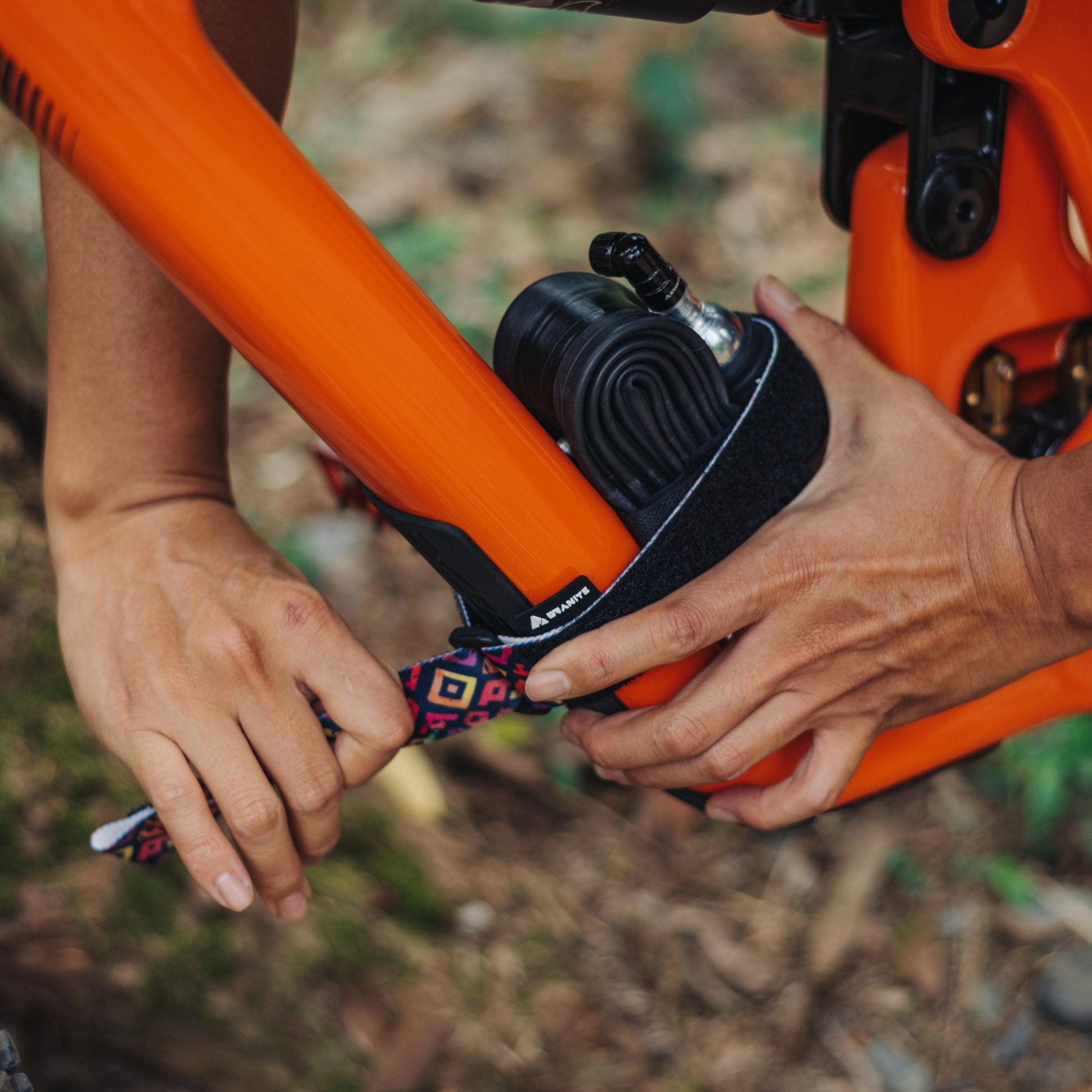 Securing a Granite Rockband Plus with square tile pattern on an bike frame, holding a spare inner tube and CO2 inflator.