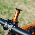 Granite stash multitool integrated into an orange bike steerer tube, installed on a Funn Crossfire handlebar stem.