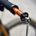 Granite Stash tire plug tool installed in bike handlebar end with a wrench attached.