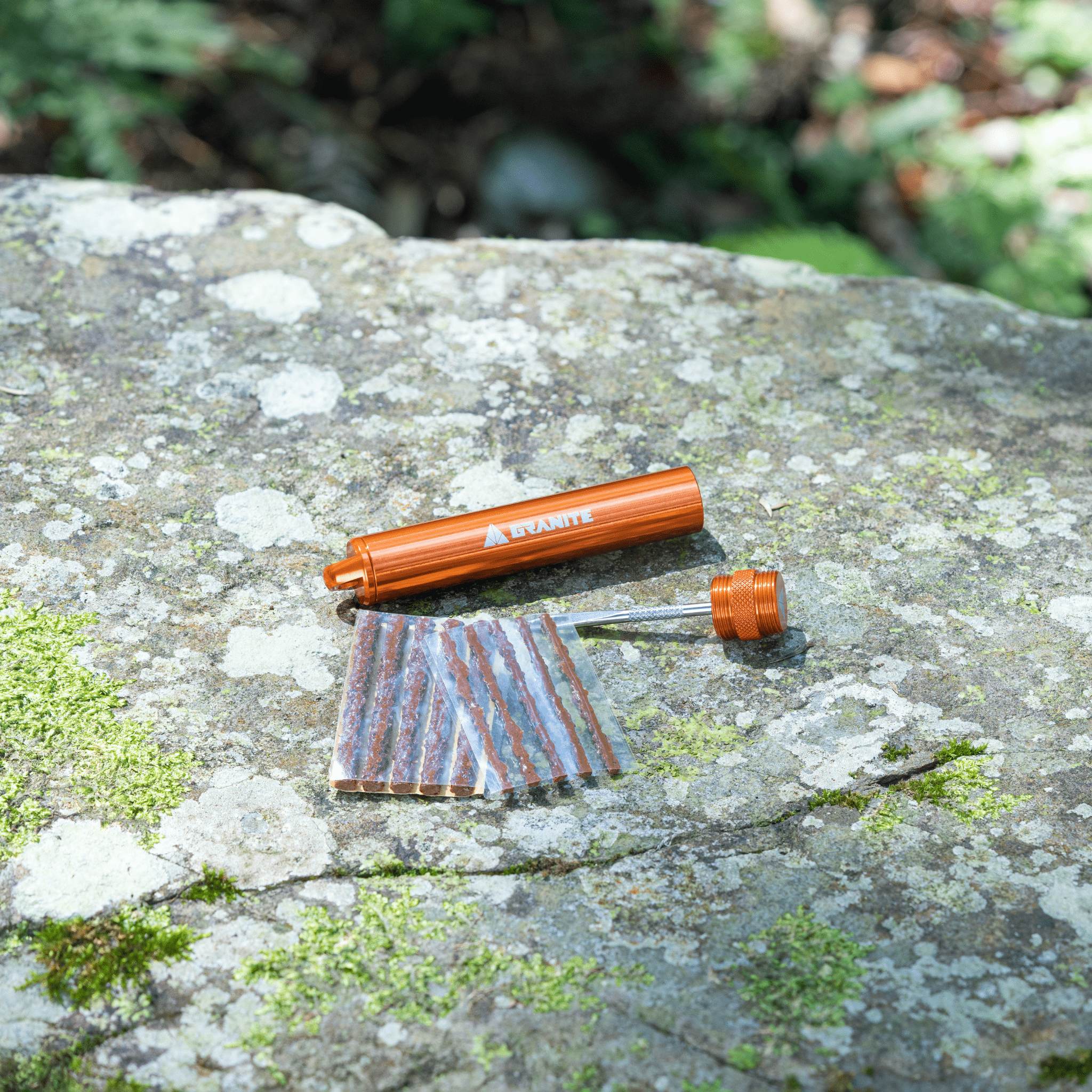 Granite Suture Tire Plug Kit Orange with Tire plug refill 10pcs on a rock