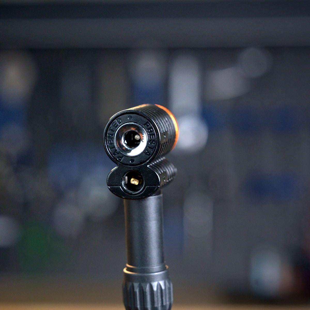 Granite Quickie pump head installed on a floor pump hose in a bike workshop