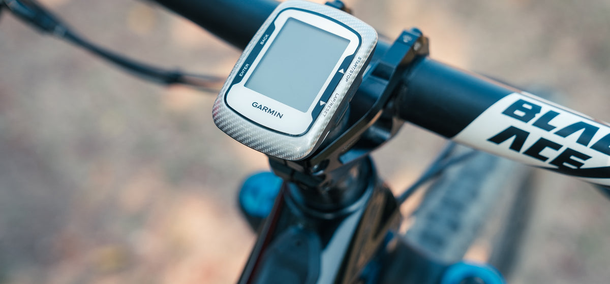 White Garmin bike computer on a Granite Scope mount over the stem of a Specialized mountain bike