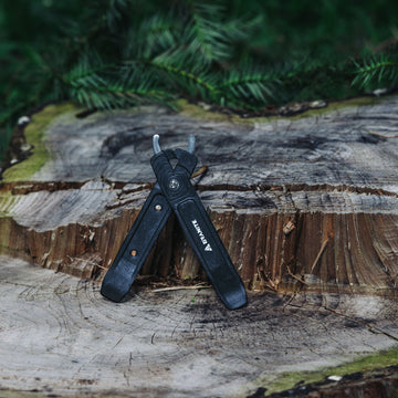 Black Granite Talon tire levers clipped together and leaning on a tree stump